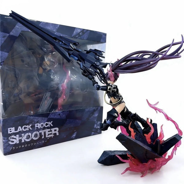 Black Rock Shooter collectible figure posed beside its retail box on a white background. The figure is a female character with long dark purple hair, wearing black and beige outfit details, holding a large black gun-like weapon, and standing on a dark base with pink translucent flame accents.