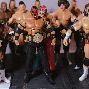 WWE action figures with a focus on a central figure holding a championship belt.
