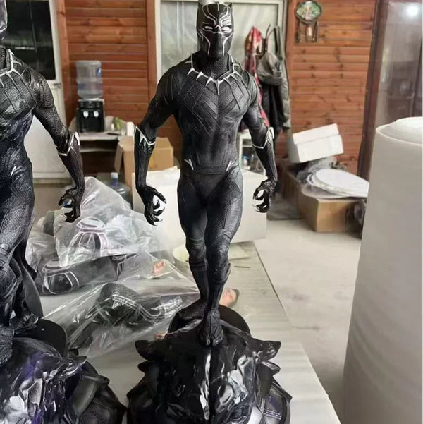 Black Panther statue on a table with a wooden wall background