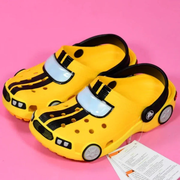 Yellow children's shoes with black stripes on a pink background