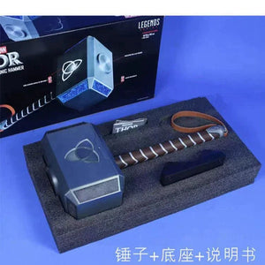 Model of Thor's hammer with packaging on a blue background